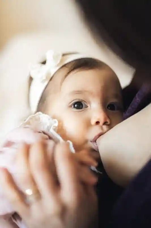 Bambina che beve dal seno